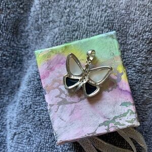 Two pairs of earrings and matching butterfly charm